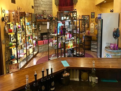 The inside of a wine shop with bottles on the counter. Book car for wine tour.