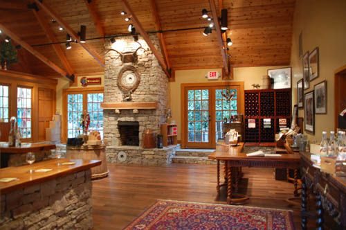 A large room with a fireplace and stone walls, perfect for hosting a cozy gathering or relaxing by the fire.