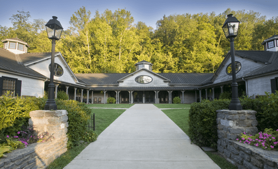 The entrance to a building with a stone walkway.