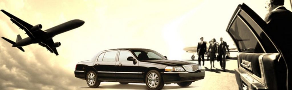 A black limo is parked next to a plane.