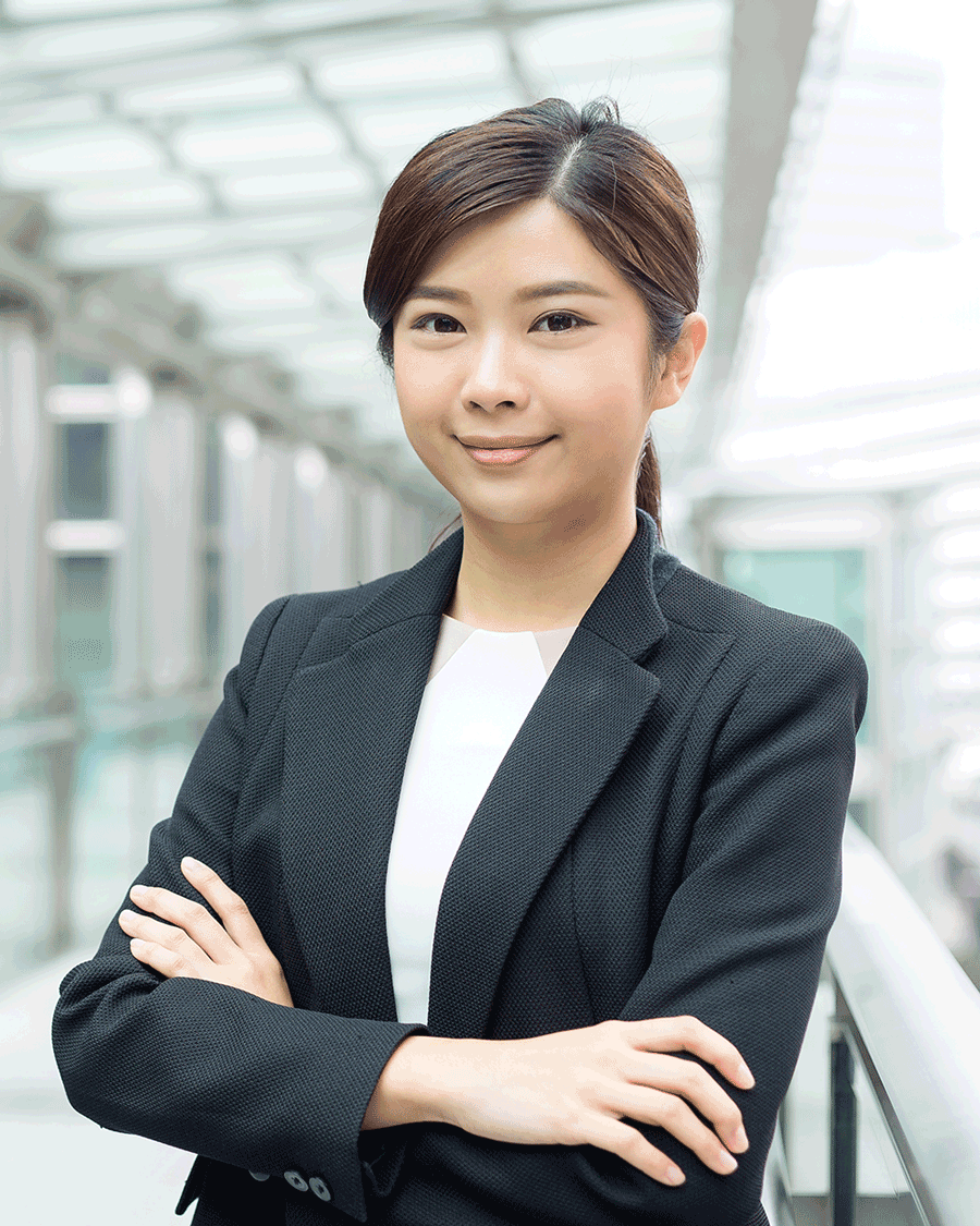 A woman in a business suit is posing for a picture.