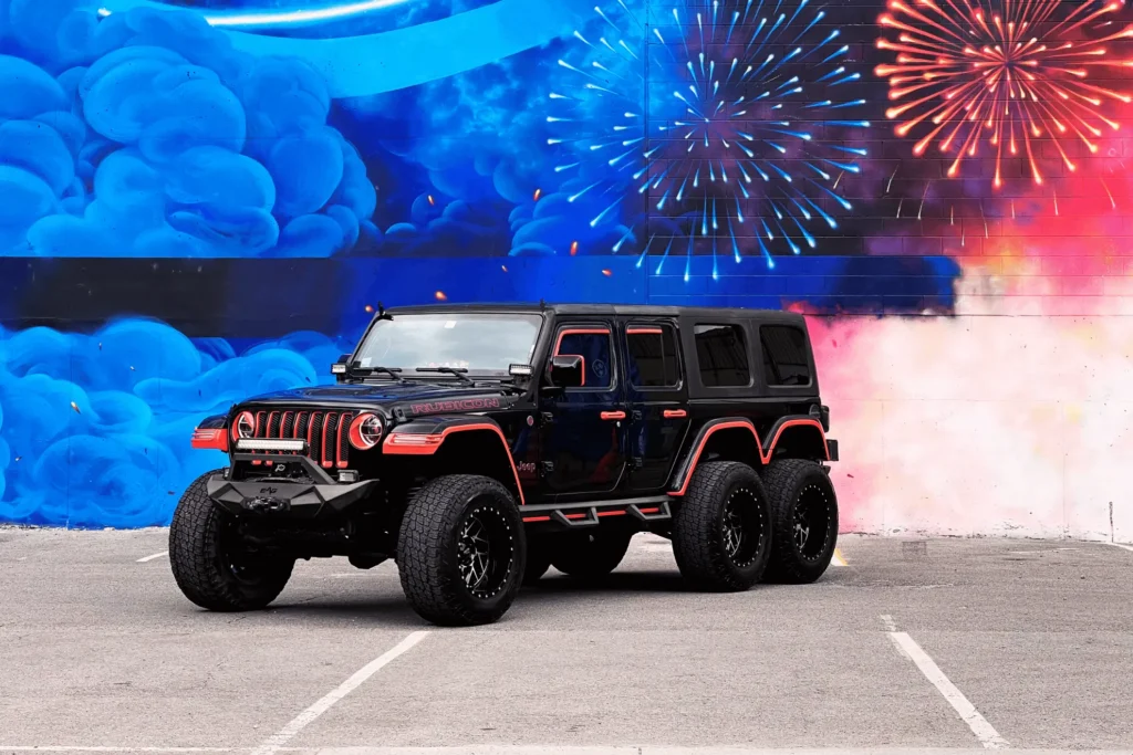 A jeep parked in front of a firework painting.