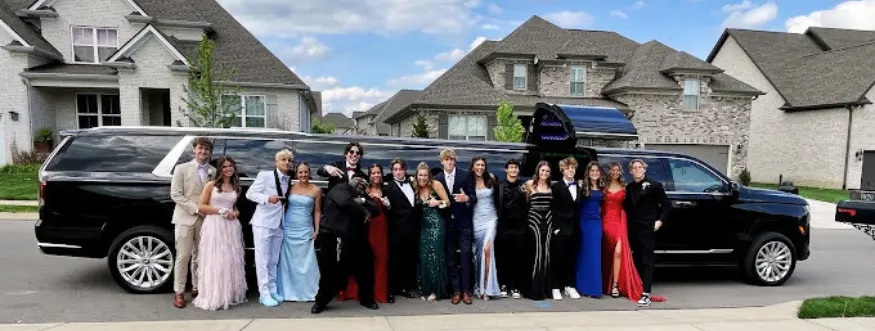 A group of friends taking a picture of their prom dresses