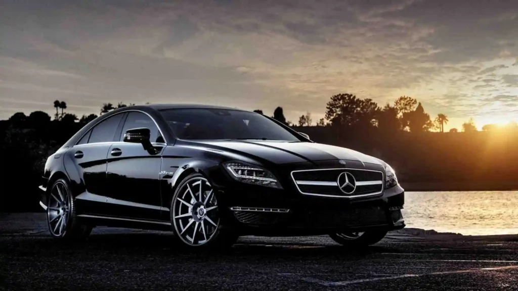 Black Mercedes sedan car parked in sunset