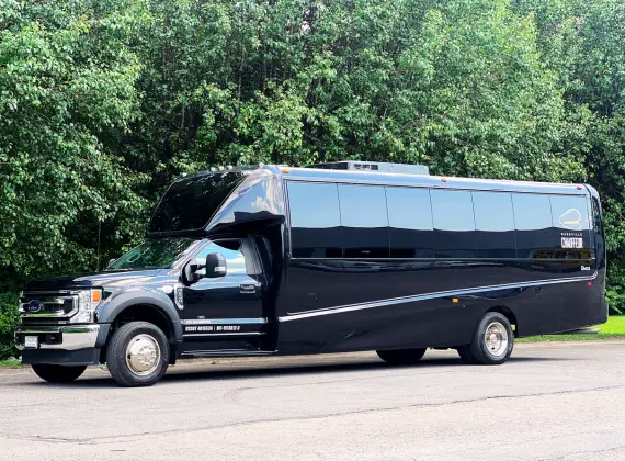 A navy blue 31 Passenger bus