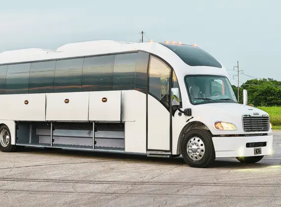 White coach bus parked in a parking lot