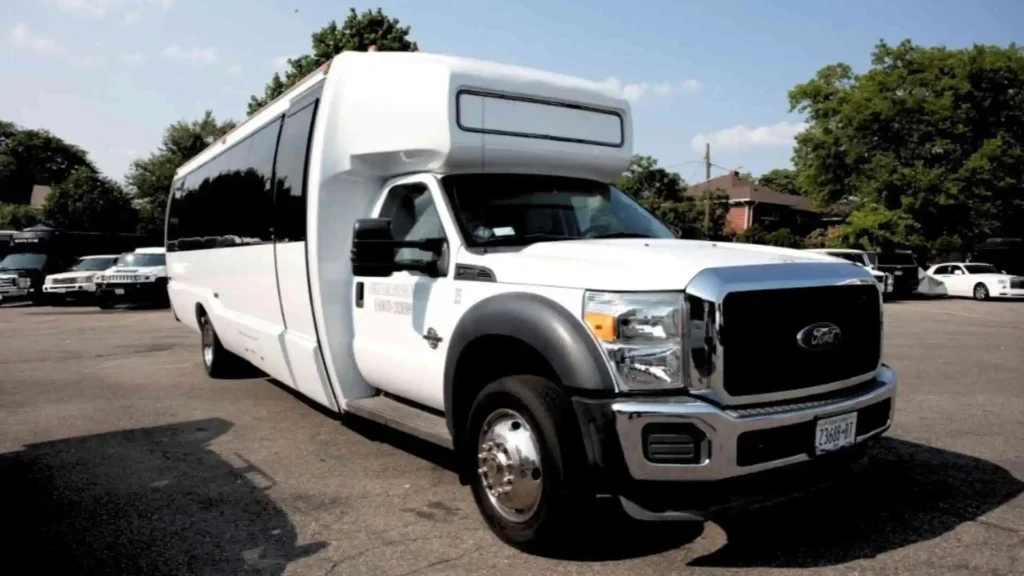 White hummer limo bus parked in a parting lot